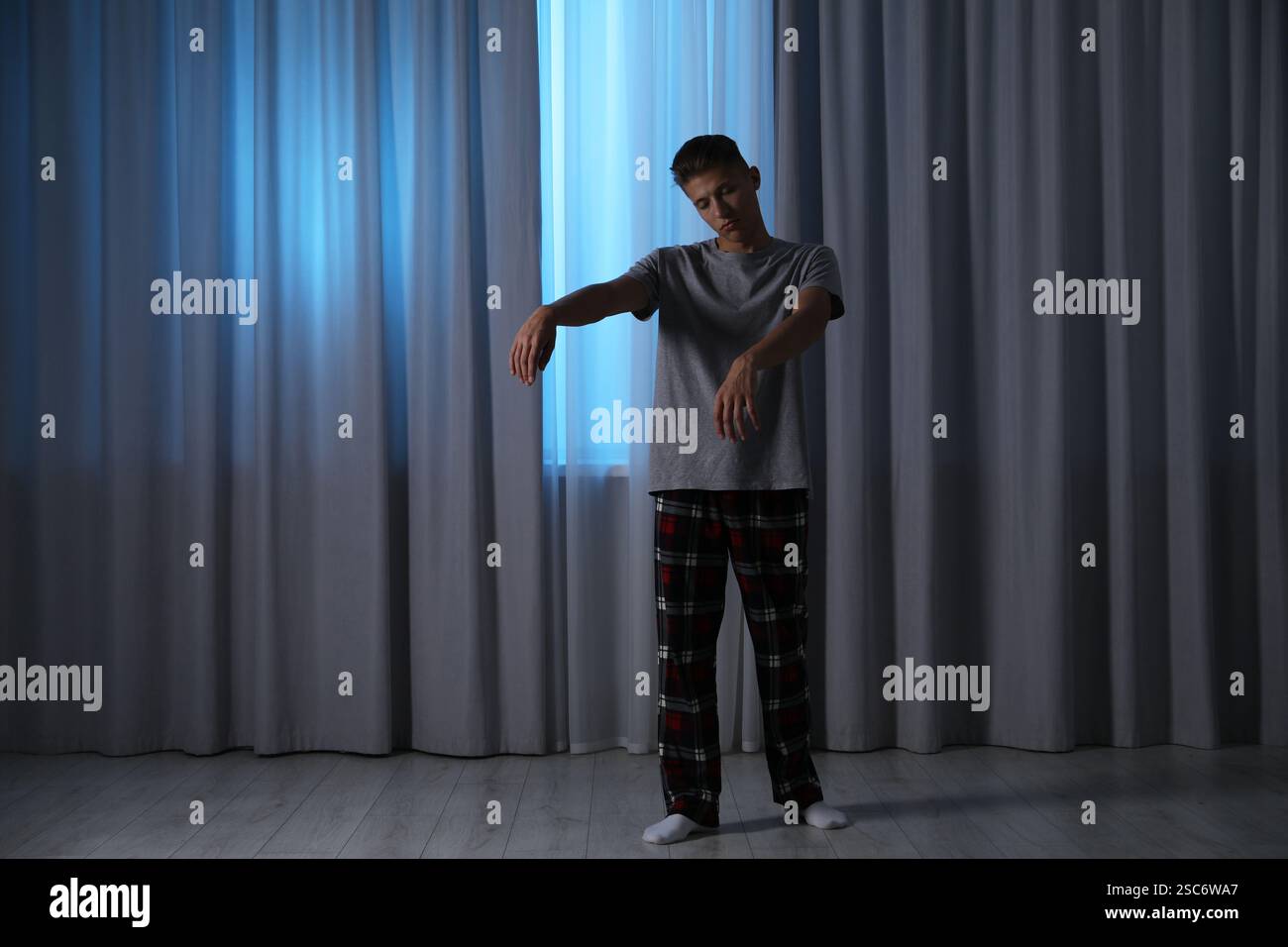 Young man suffering from sleepwalking at home Stock Photo