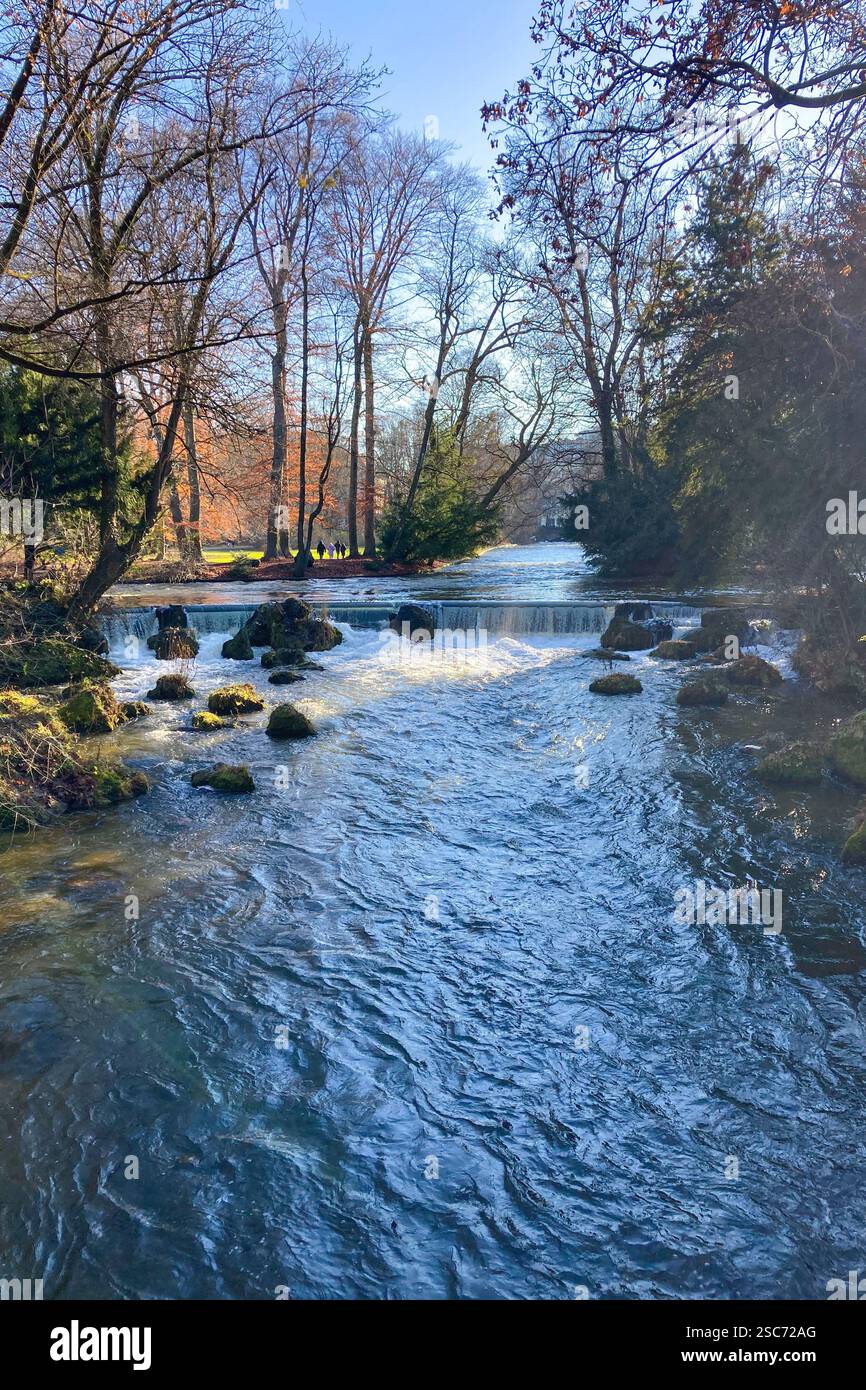 MUNICH, GERMANY - DECEMBER 2, 2024: Surfers on Eisbach river in the English garden in Munich, Bavaria - Smartphone Captured Stock Image