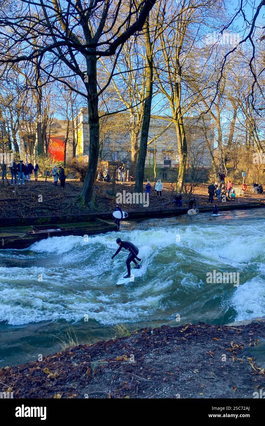 MUNICH, GERMANY - DECEMBER 2, 2024: Surfers on Eisbach river in the English garden in Munich, Bavaria - Smartphone Captured Stock Image