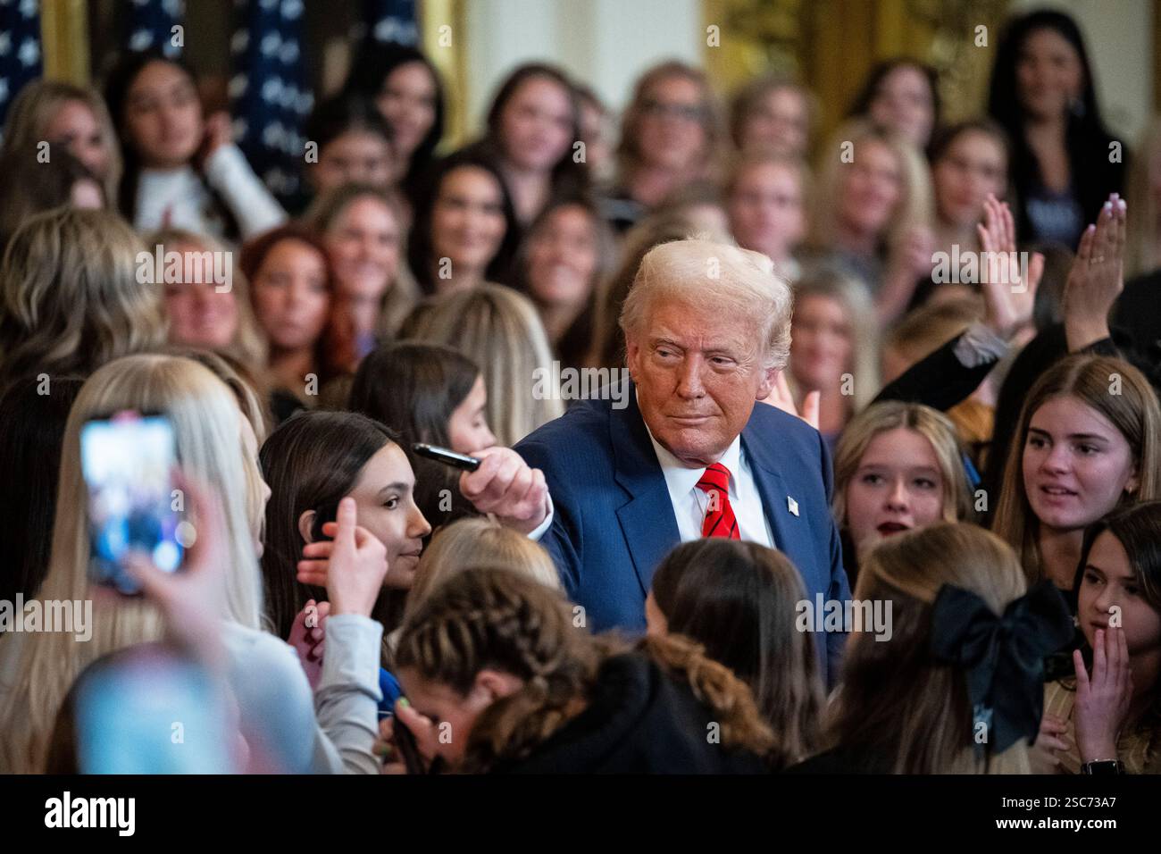 Washington, USA. 05th Feb, 2025. U.S. President Donald Trump hands out ...