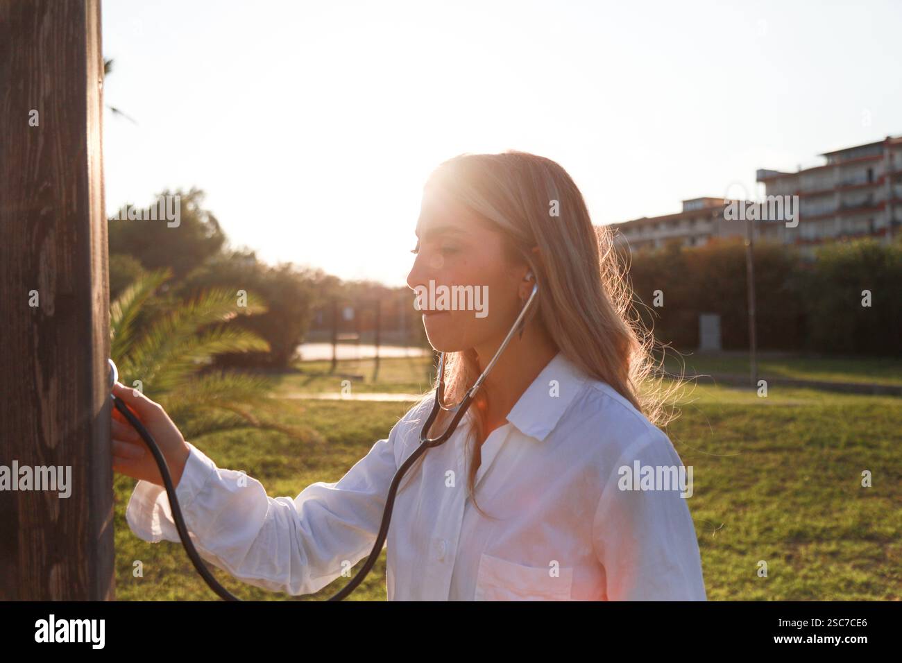 Woman Doctor Using stethoscope In Open Air Stock Photo - Alamy