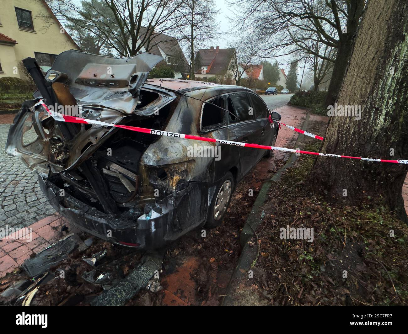 26.12.2024, Germany, Lower Saxony, Verden Police tape around burned