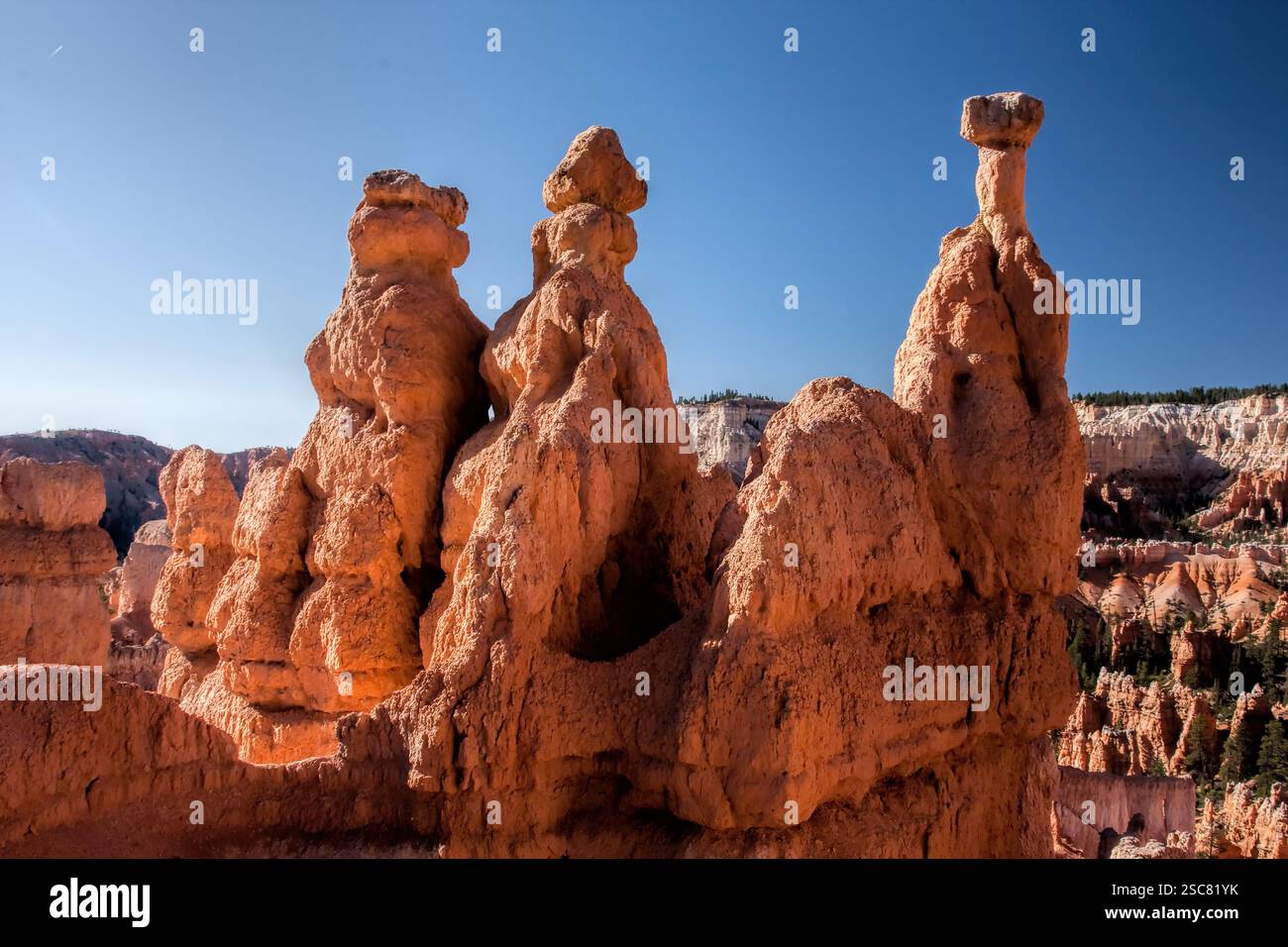 Three rock formations with a small peak on top. The rocks are brown and ...