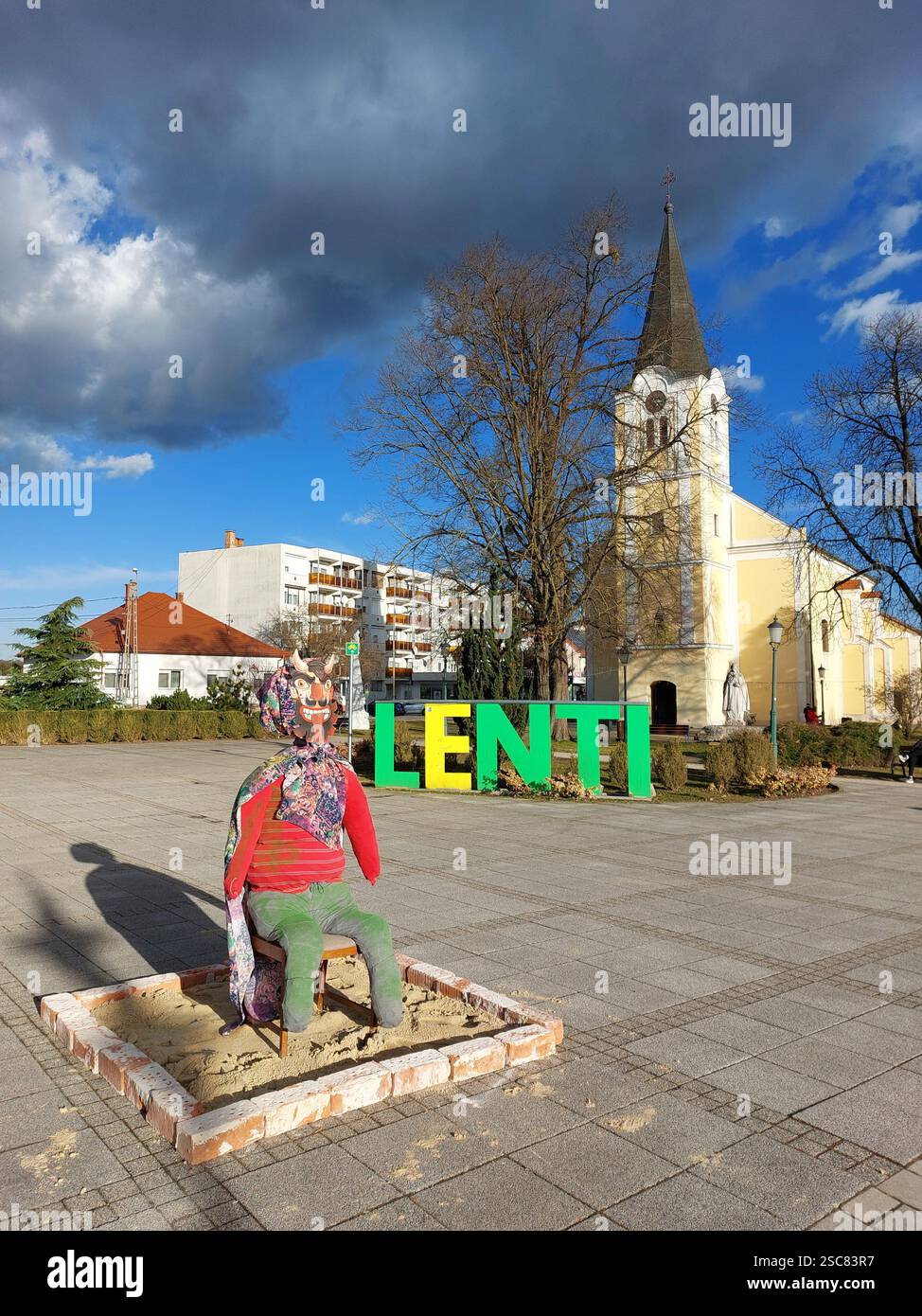 Traditional Mohacs Effigy Sat On Chair In Town Centre To Promote An traditional-mohacs-effigy-sat-on-chair-in-town-centre-to-promote-an