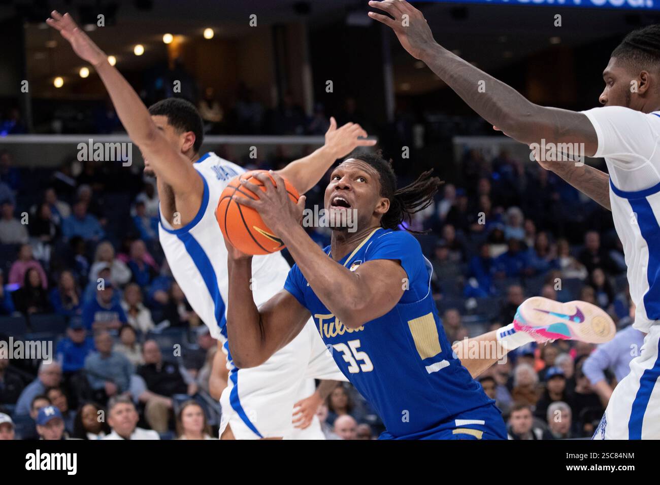 Tulsa forward Ian Smikle (35) shoots defended by Memphis forward ...