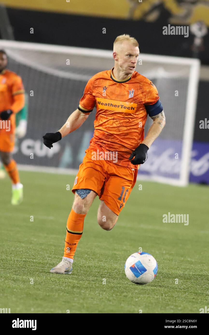 Kyle Bekke #10 of Forge FC drives the ball forward against Monterrey FC ...