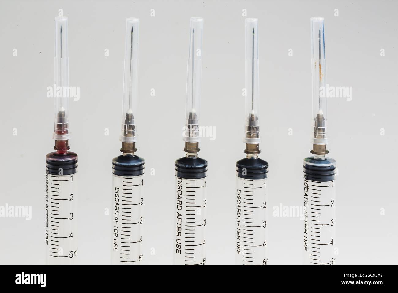 Scroll Syringe Closeup, Disposable syringe in the row on white background Stock Photo ...