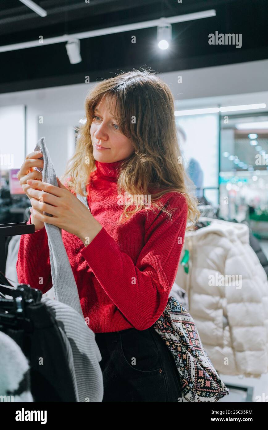 Young female customer carefully selecting hi-res stock photography and ...