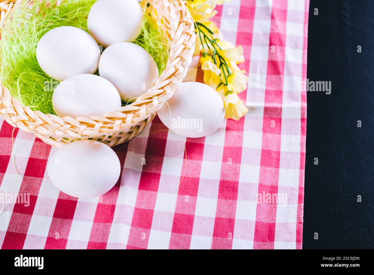 Eggs on tablecloth over black background Stock Photo