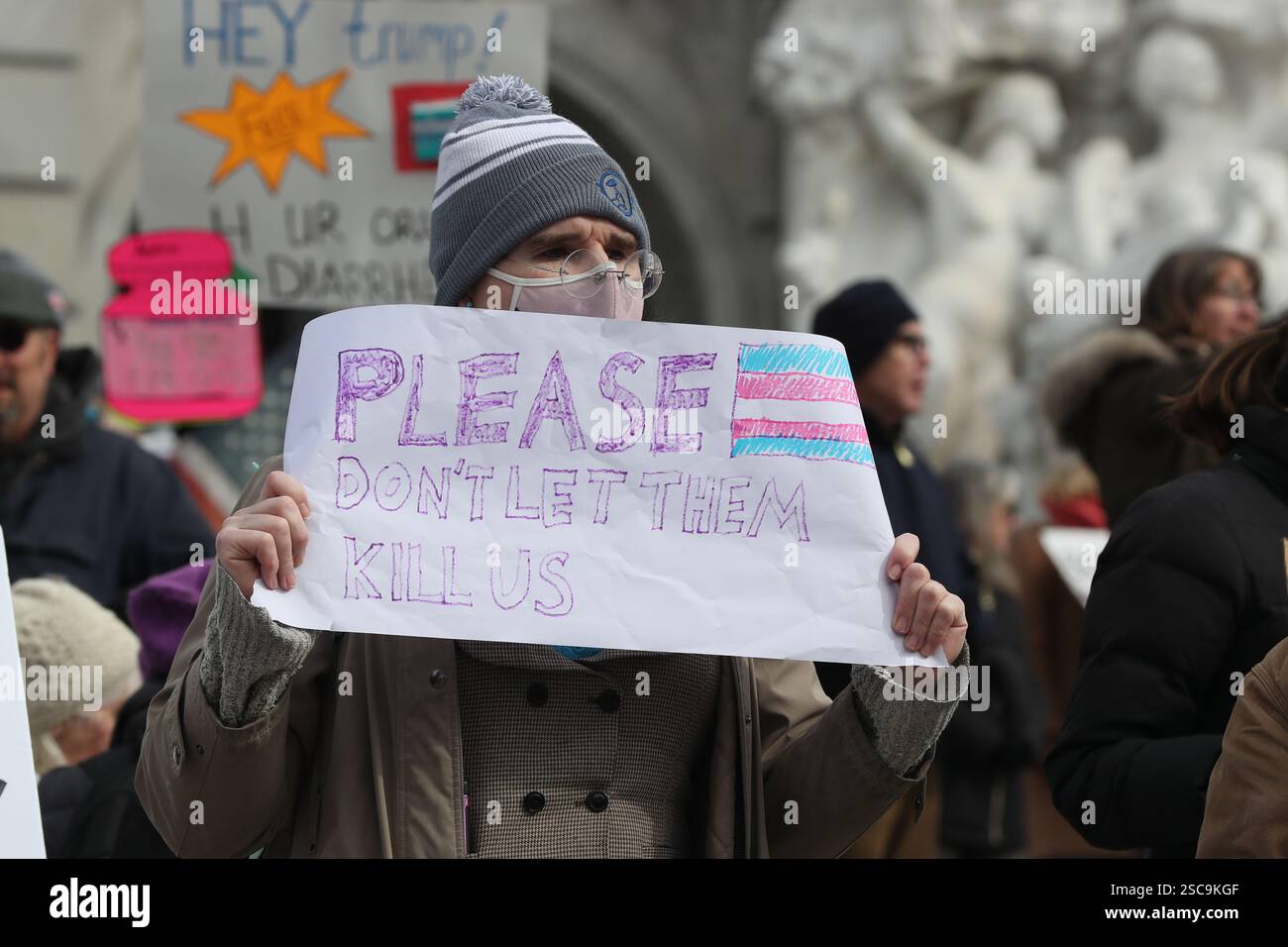 A protester holds a placard outside of the Pennsylvania Capitol during