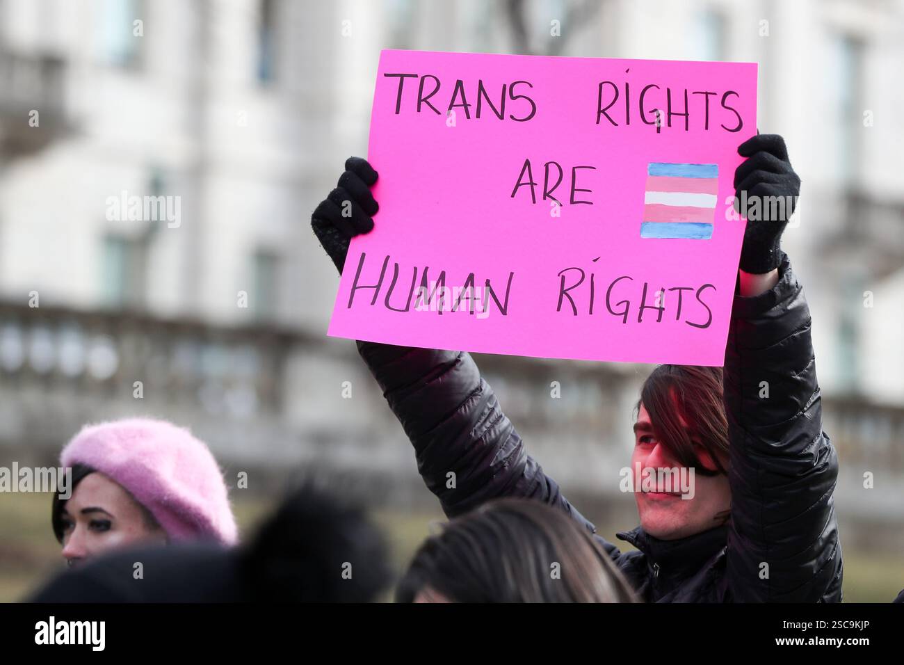 A protester holds a placard outside of the Pennsylvania Capitol during