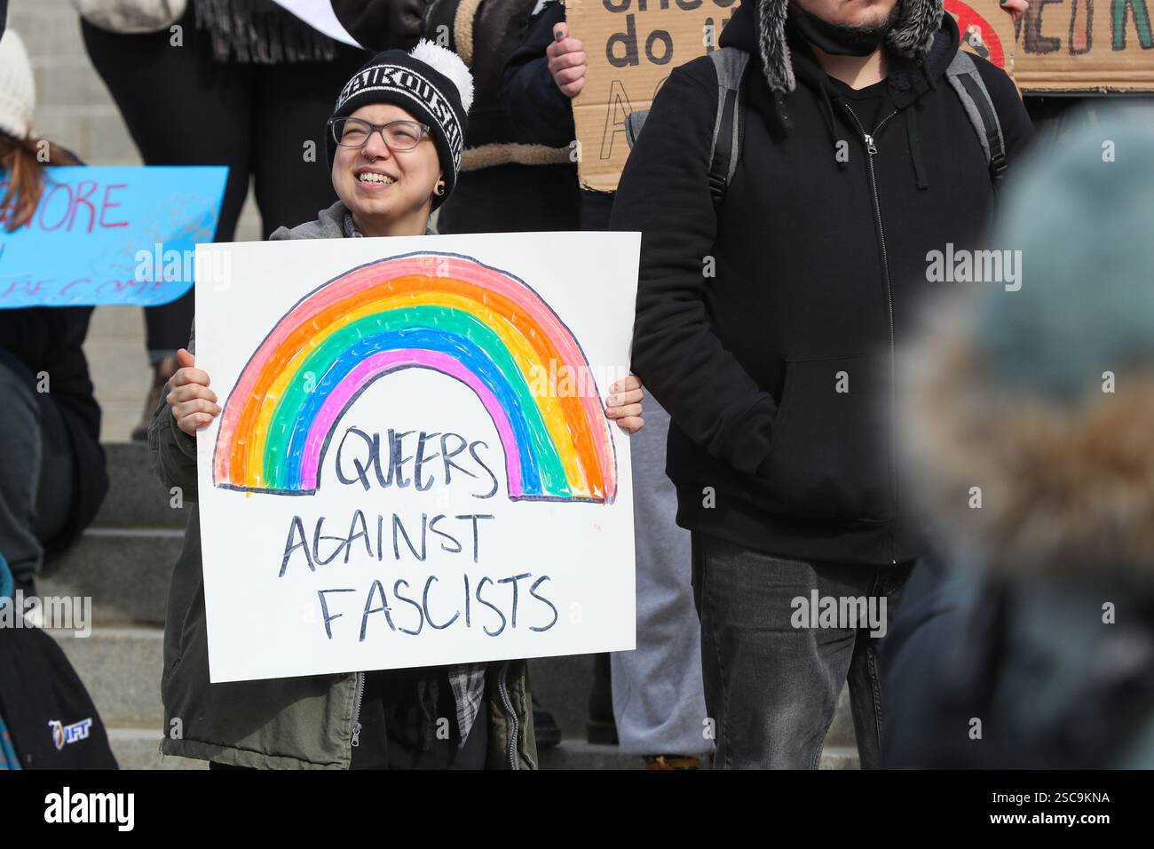 A protester holds a placard outside of the Pennsylvania Capitol during