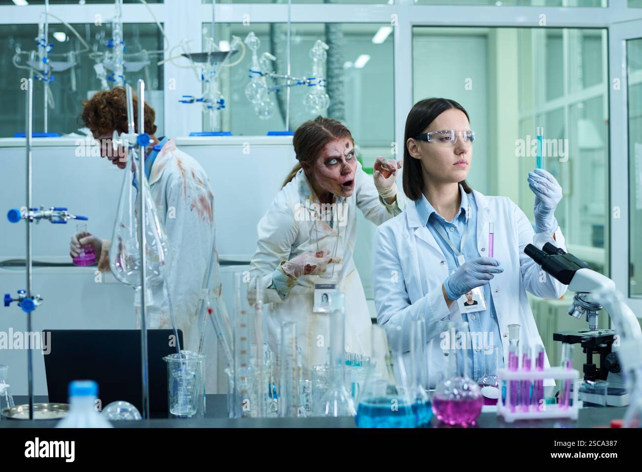 Serious Woman Working In Lab Full Of Zombies Stock Photo - Alamy