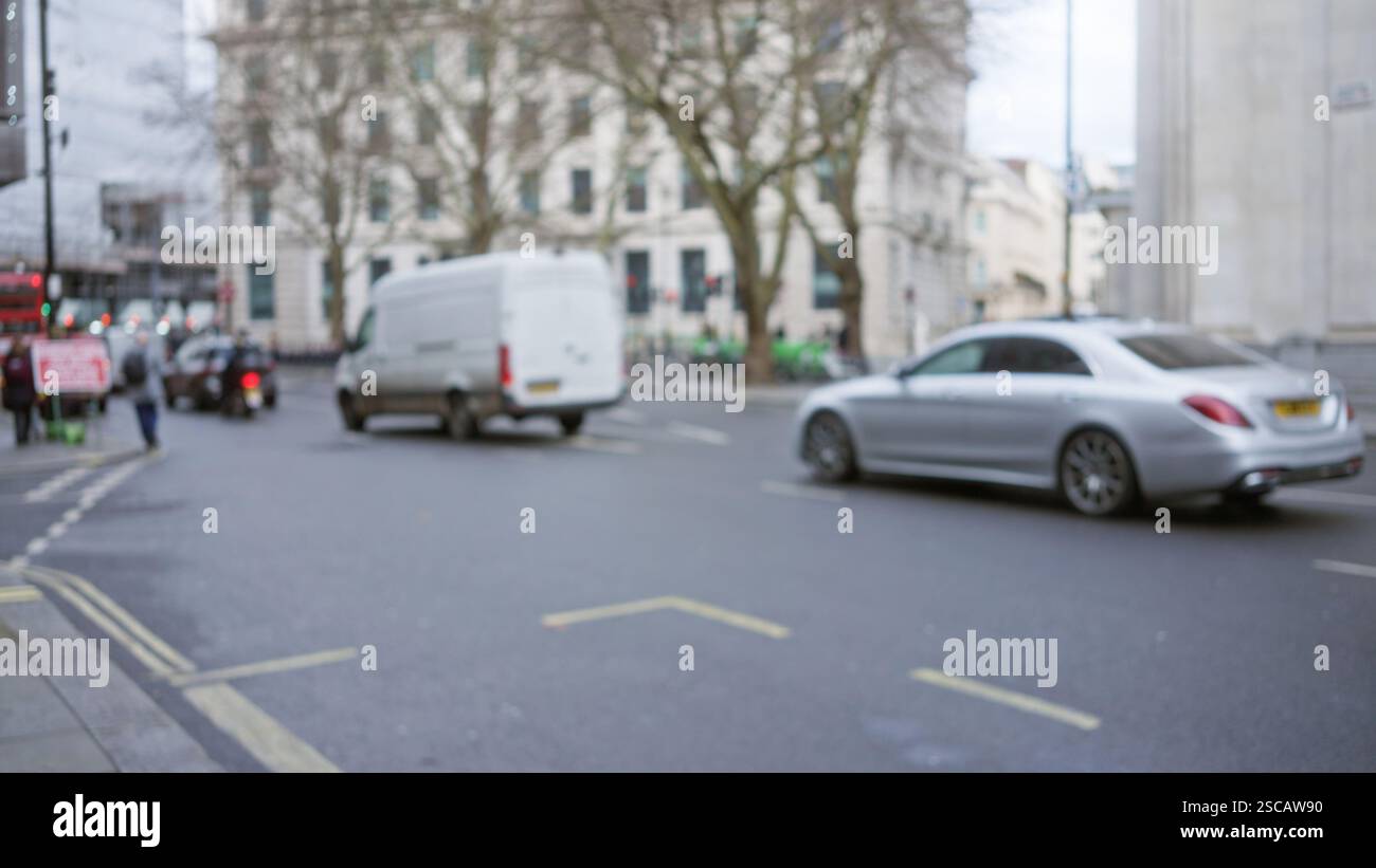 Blurred city street in london with cars and pedestrians creating a ...