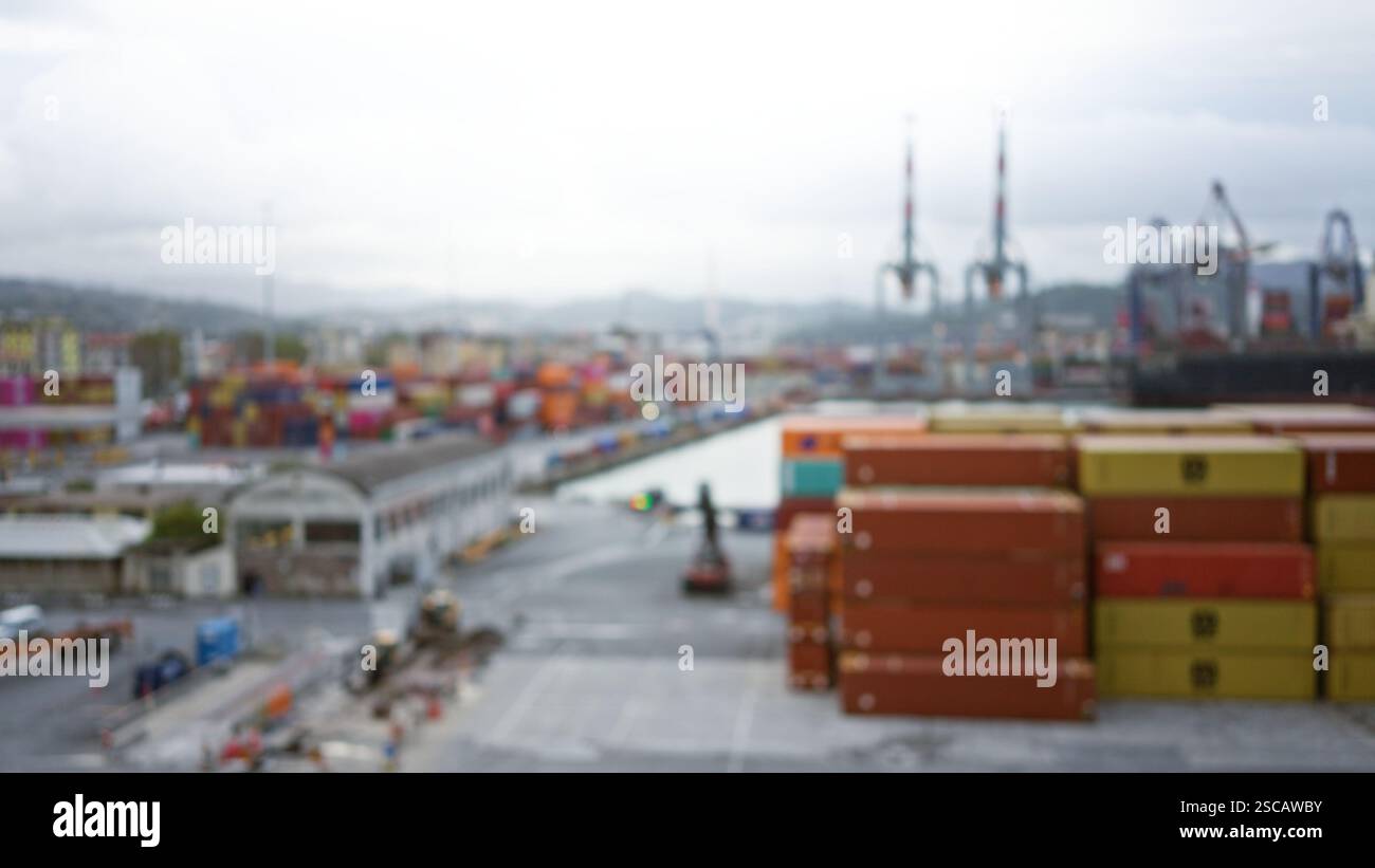 Blurred cargo port scene featuring stacks of colorful containers and ...
