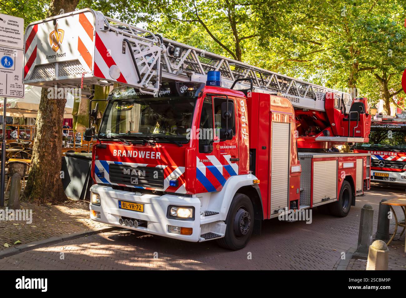 Red Dutch fire trucks on a narrow street in the center of Amersfoort. Stock Photo