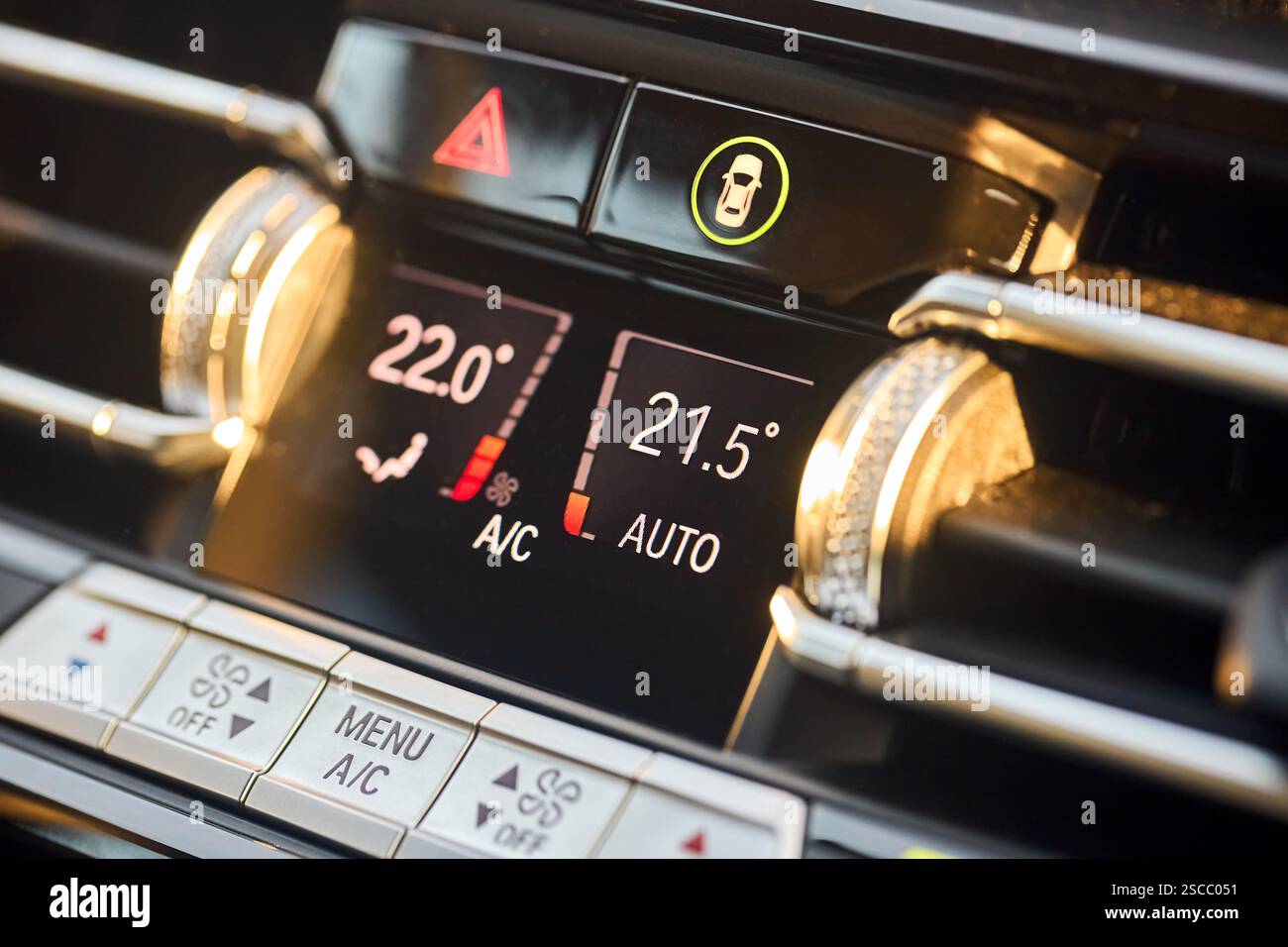 Automotive detailing climate control display dashboard with mode buttons close up. Luxury contemporary car interior detail selective focus shot. Stock Photo