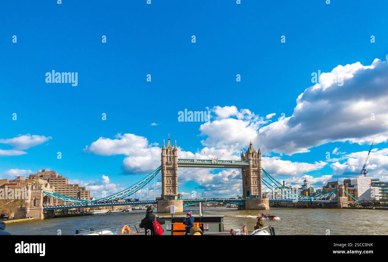 Large panorama of the renowned Tower Bridge, viewed from a tourist boat on the River Thames in London. Tower Bridge is a Grade I listed combined... Stock Photo
