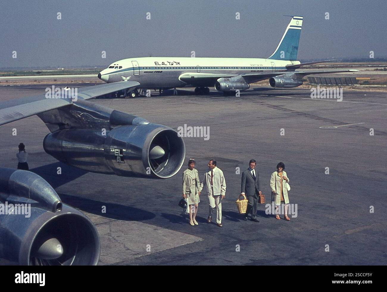 Passengers leave the airport Lod in Tel Aviv. In the back a plane. Stock Photo