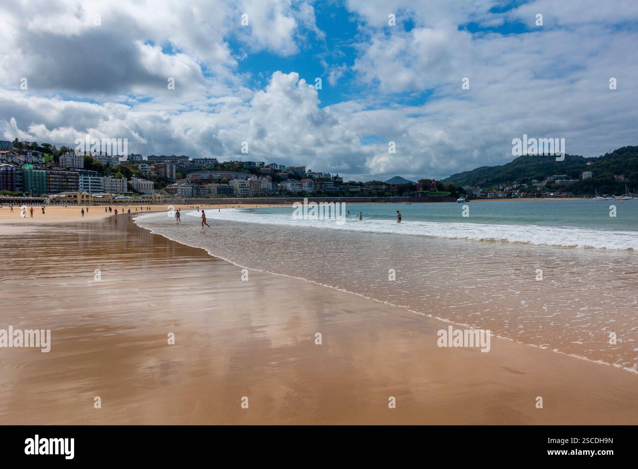 Visitors stroll along the sandy beach of San Sebastian, enjoying the ...