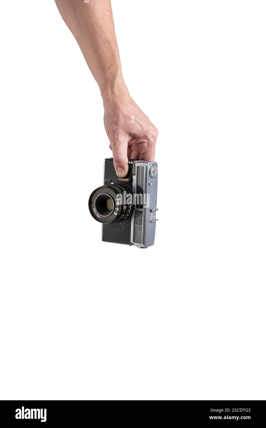 Old camera in hand isolated on white background Stock Photo