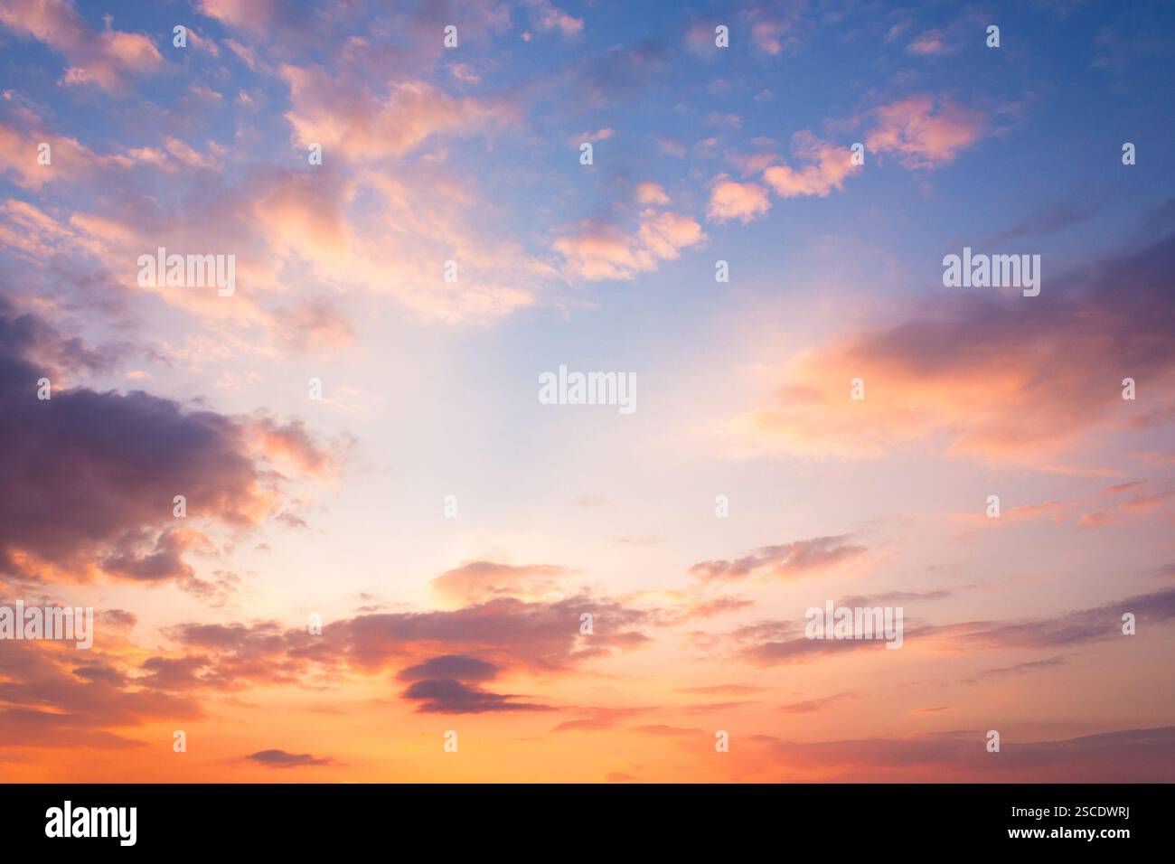 changing weather forecast. air pressure. scenic cloudscape. red clouds on the bue evening sky. dramatic sunset background. romantic fantasy wallpaper Stock Photo