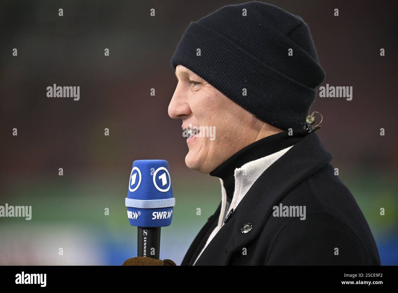ARD TV expert Bastian Schweinsteiger, cap, portrait in interview, microphone, microphone logo DFB Cup, MHPArena, MHP Arena Stuttgart, Baden-Wuerttembe Stock Photo