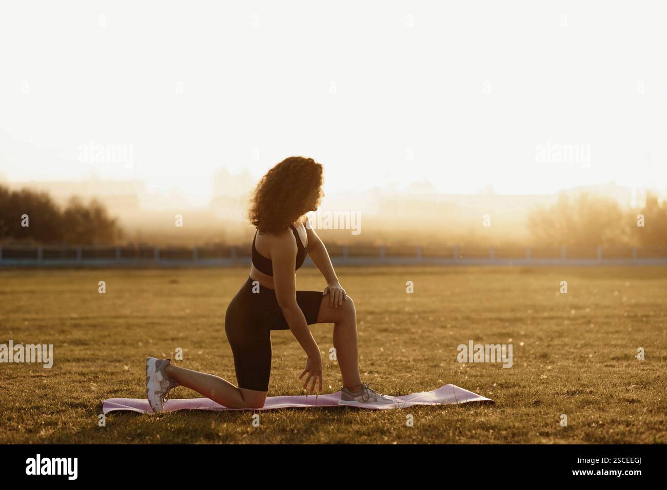 Woman kneeling in field hi-res stock photography and images - Alamy