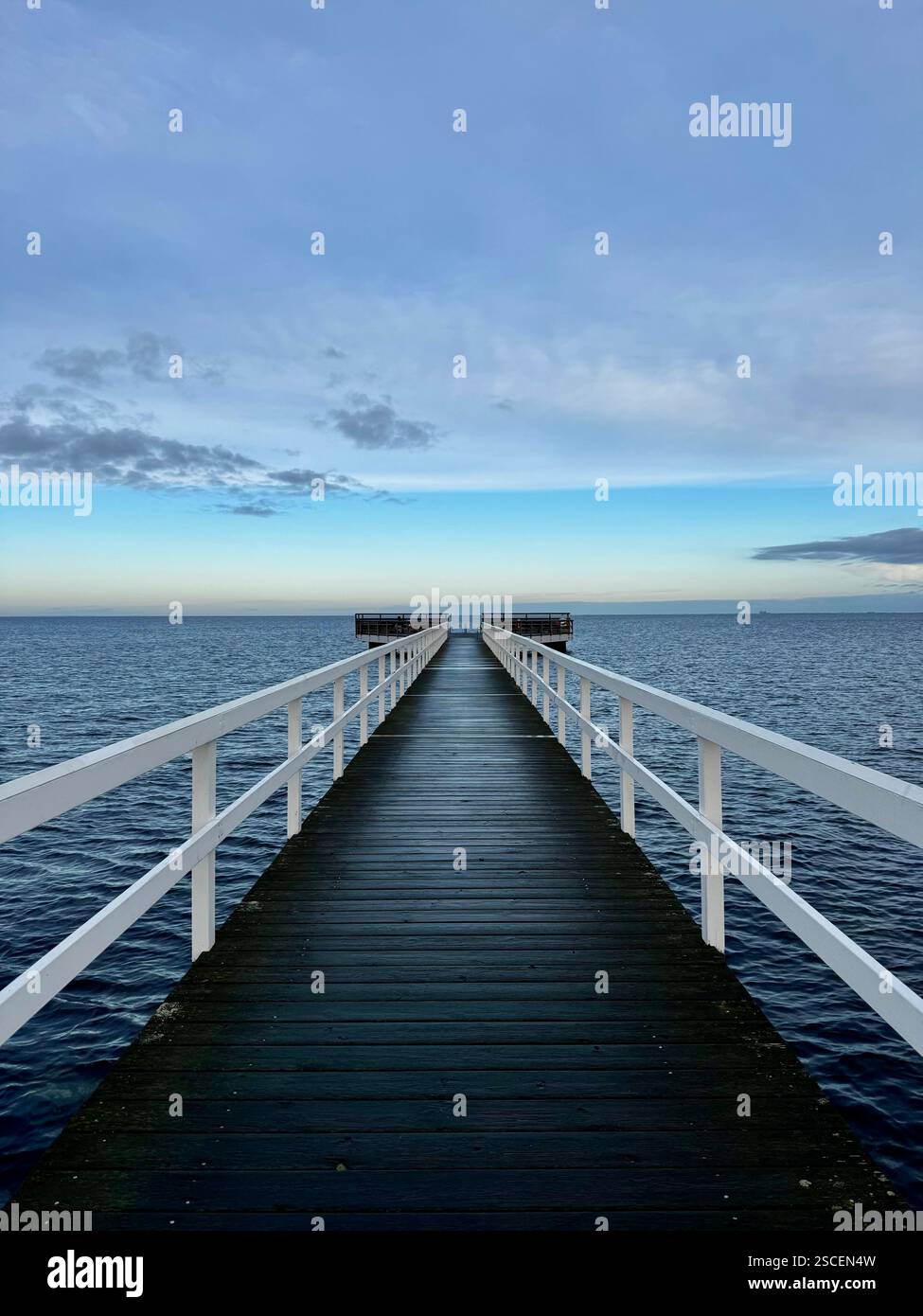 Embracing the Nordic way: A wooden pier on the Baltic Sea in Malmö, Sweden, invites locals to a refreshing cold plunge on a crisp winter morning. - Smartphone Captured Stock Image