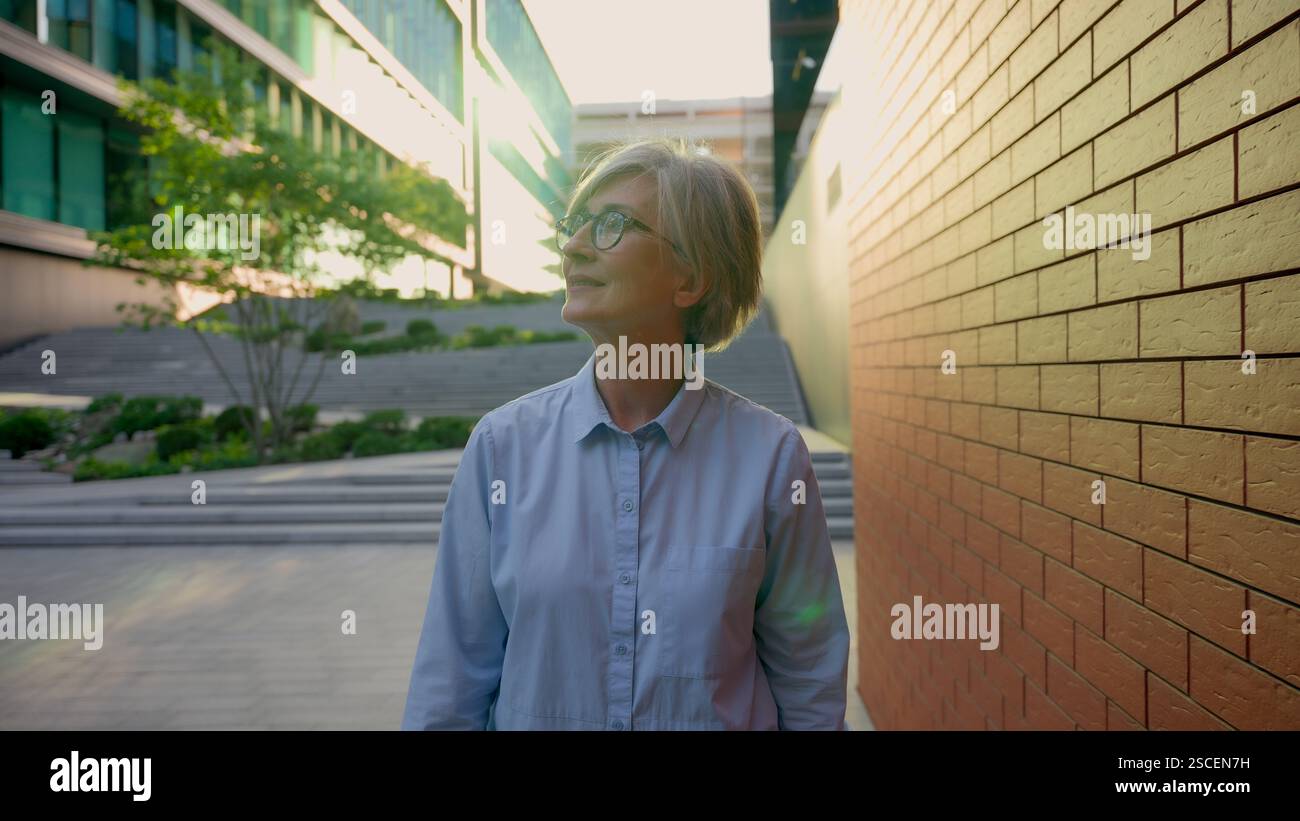 Older woman walking street hi-res stock photography and images - Alamy
