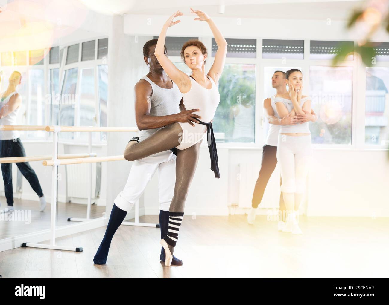 Ballet partners performing elegant dance sequence in studio Stock Photo ...