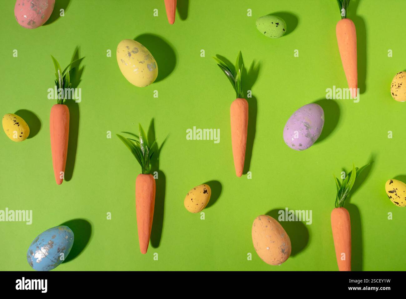 Easter pattern made with carrots on bright blue background. Creative minimal holiday concept Stock Photo