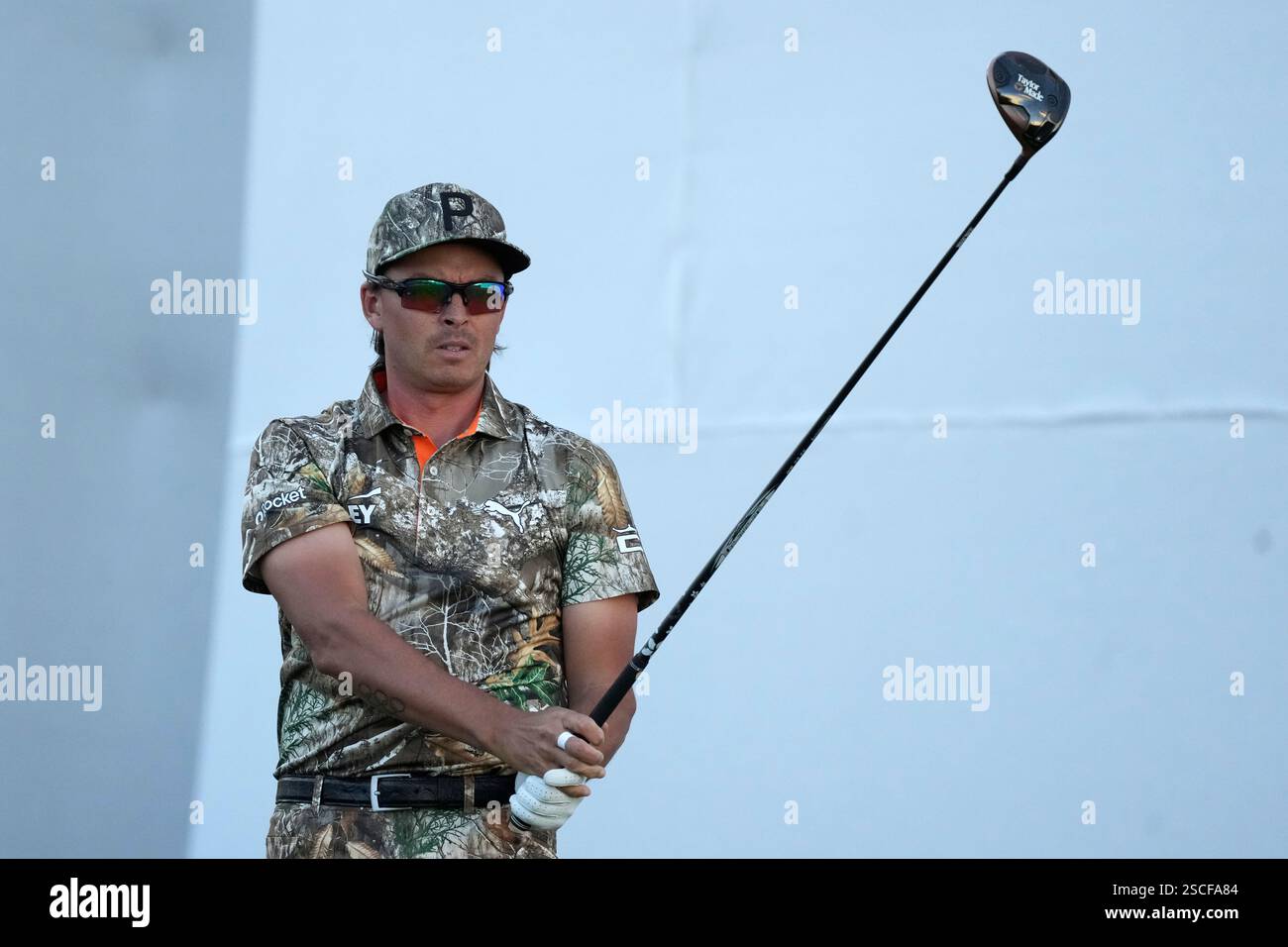 Rickie Fowler watches his tee shot at the 17th hole during the first
