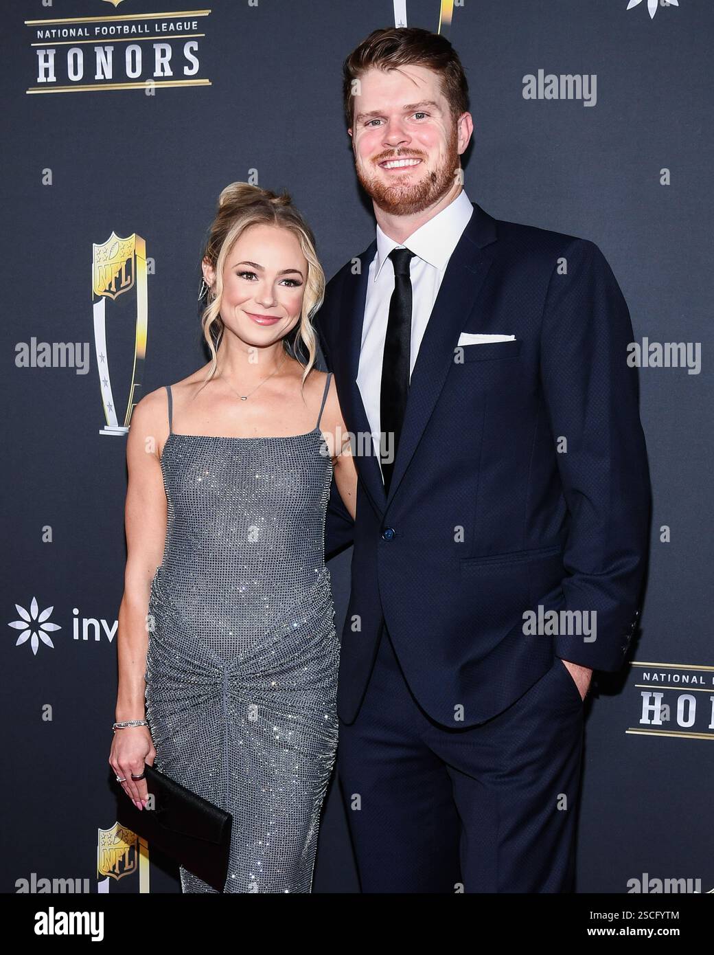 Katie Hoofnagle and Sam Darnold walking on the red carpet at NFL Honors