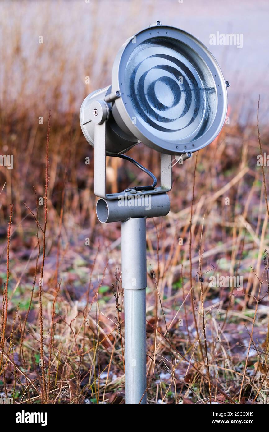 Spotlight on a pole outside Stock Photo - Alamy
