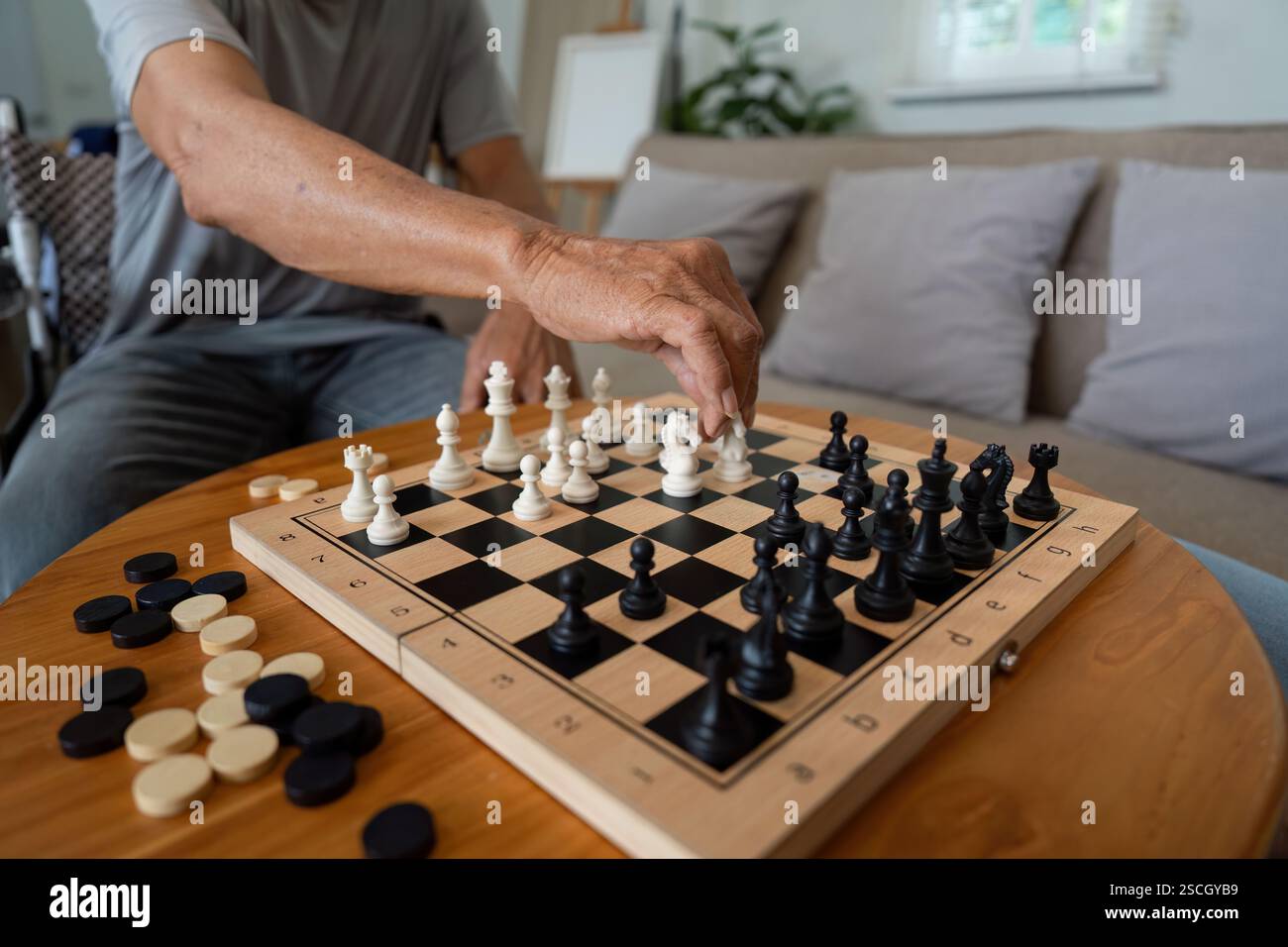 Father making a strategic move in chess game against his son Stock ...