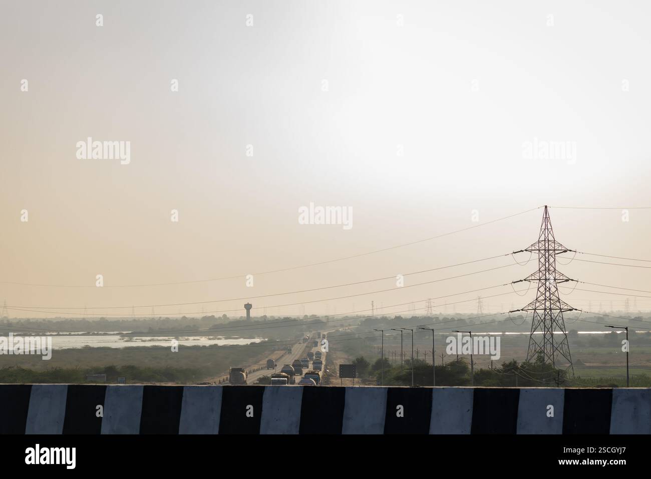 highway with traffic at hazy evening near city Stock Photo
