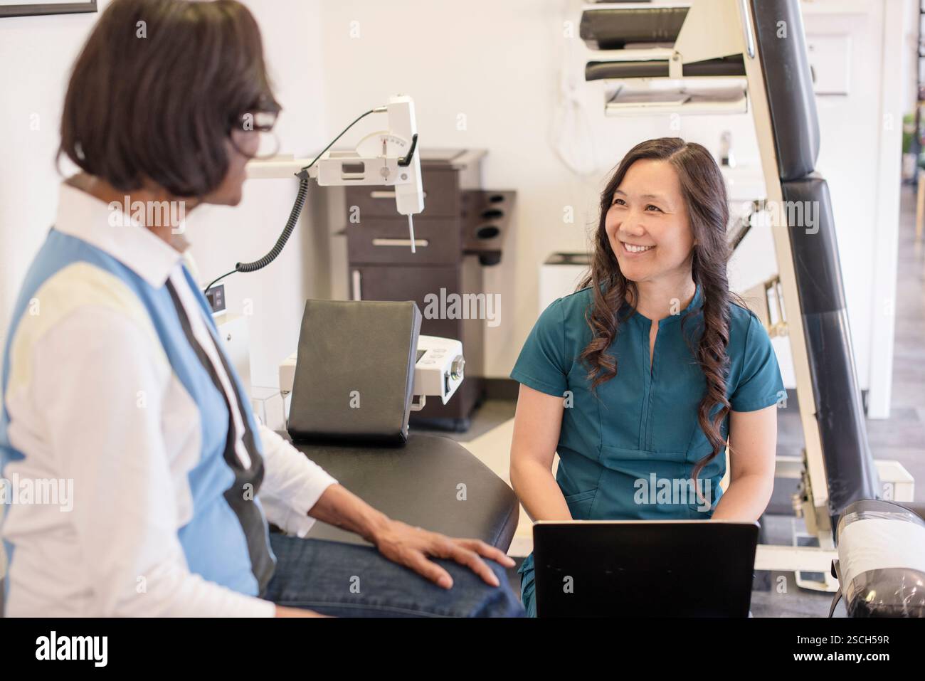 Doctor talking to patient and taking notes Stock Photo