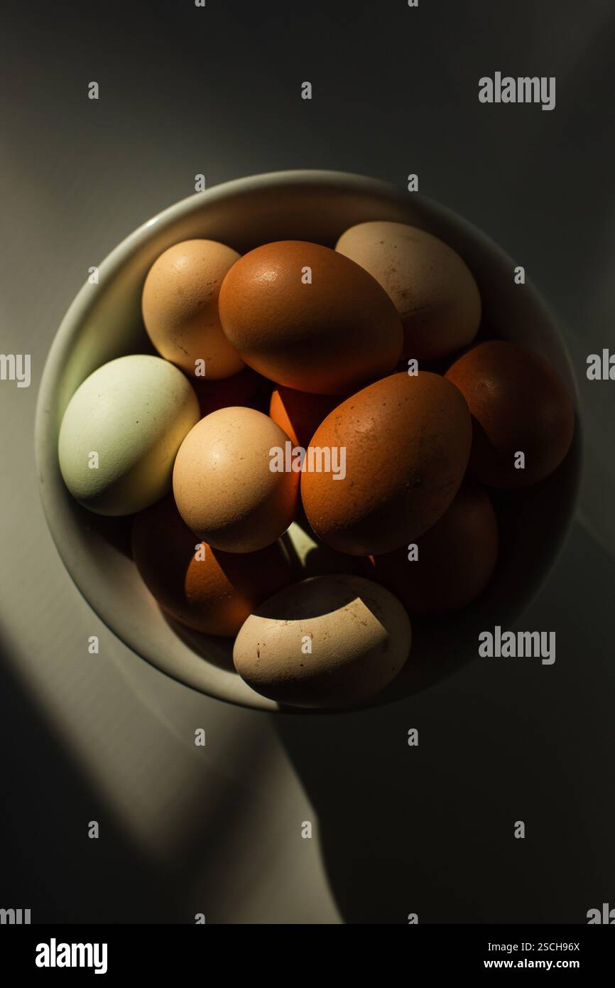 Bowl of brown eggs on table Stock Photo