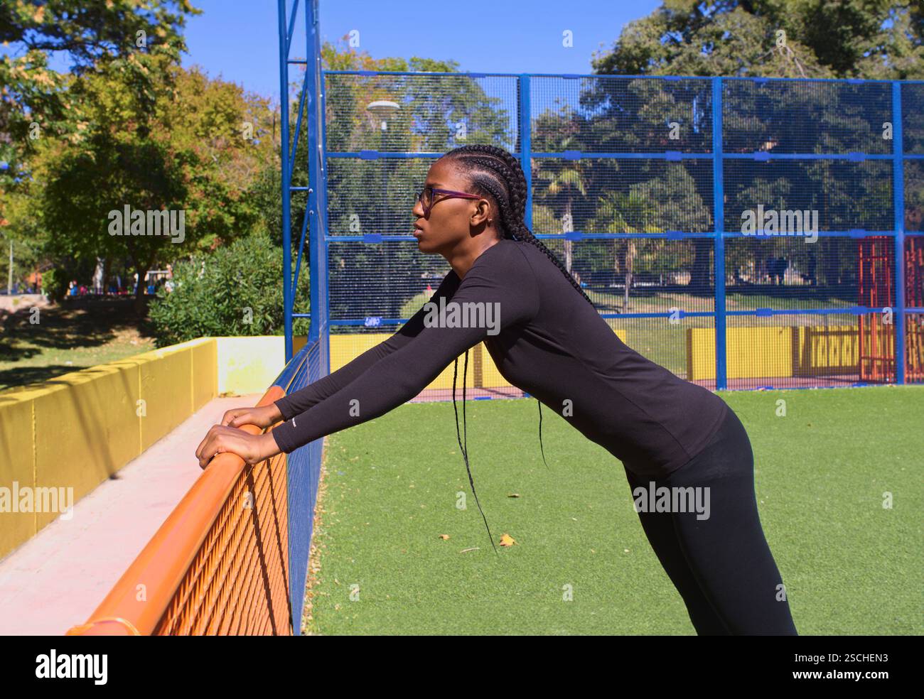 Wnba Stretchig A woman basketball player in a black outfit performs a stretching ...