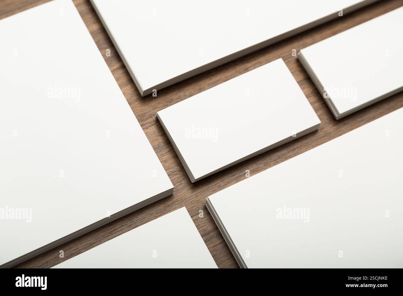 Various blank rectangular surfaces arranged on a wooden table showcasing potential for creativity and design projects Stock Photo
