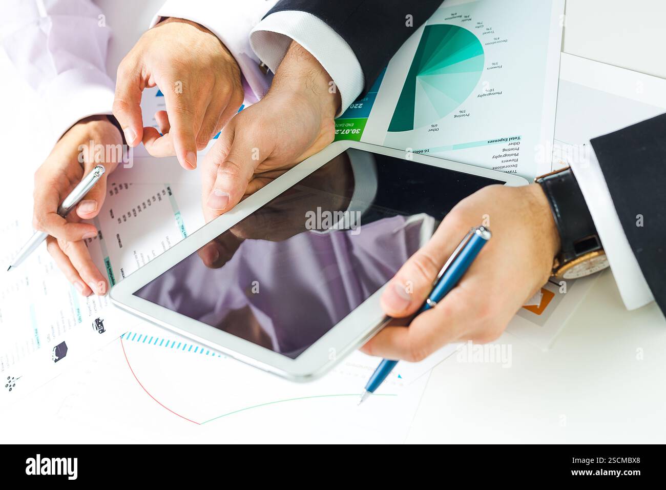 Collaboration between colleagues over business data and analysis in a modern workplace setting Stock Photo
