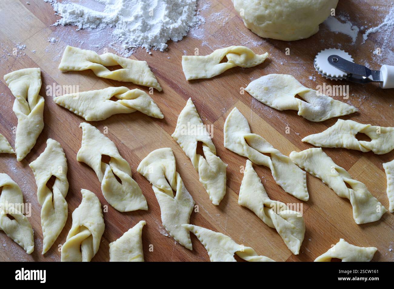 Bugnes lyonnaises. Preparing traditional French carnival sweets named ...