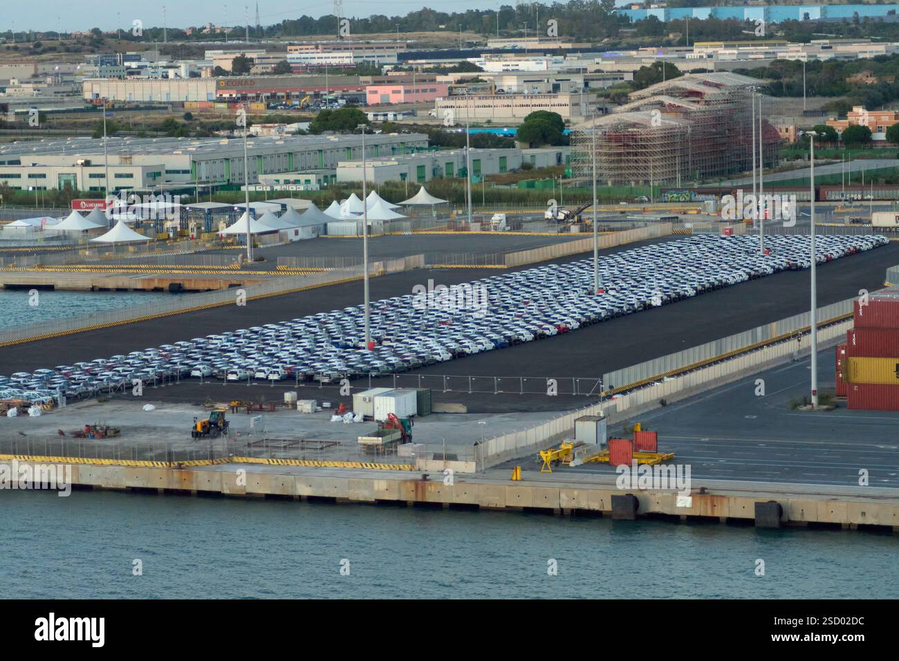 Civitavecchia, Italy - February 7, 2025: Aerial view of cars to be loaded at a port, representing logistics operations and international trade of the Stock Photo