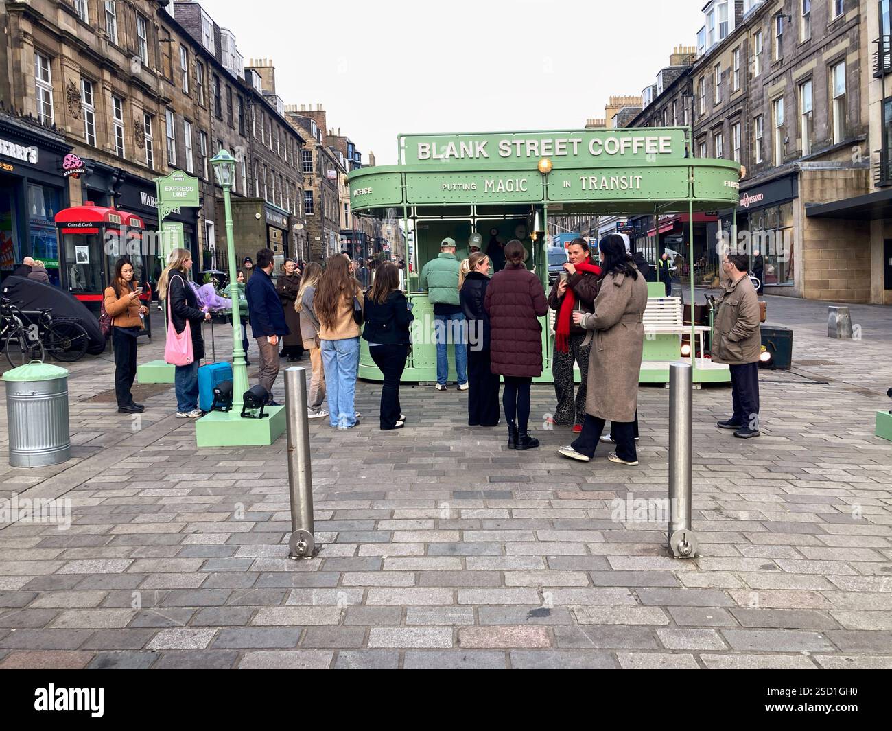Customers queuing for free tasters of the Blank Street Coffee viral coffee on Castle Street, promoting the recent opening of 2 outlets in Edinburgh - Smartphone Captured Stock Image