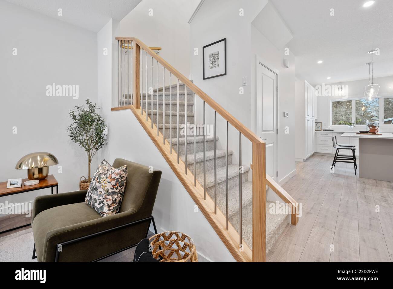 Staircase with a wooden railing and a chair in front of it. The chair ...