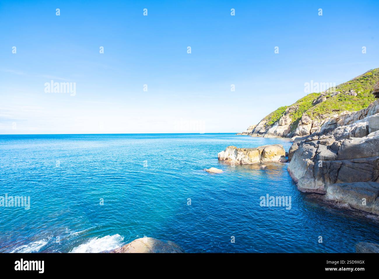 Rocky Coastal Landscape with Blue Ocean and Clear Sky Stock Photo - Alamy