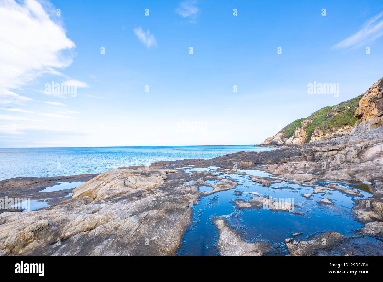 Rocky Coastal Landscape with Blue Ocean and Clear Sky Stock Photo - Alamy