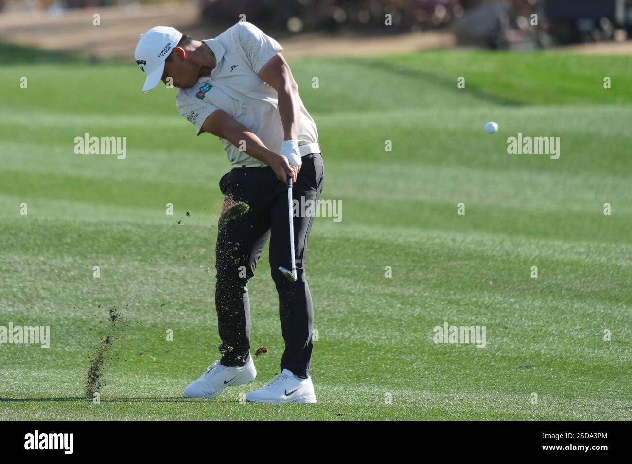 Kevin Yu, of Taiwan, hits his approach shot at the first hole during