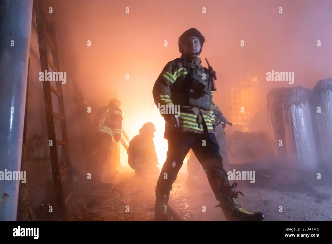 Ukraine Firemen Firefighters work at a civil factory after the Russian attack in ...